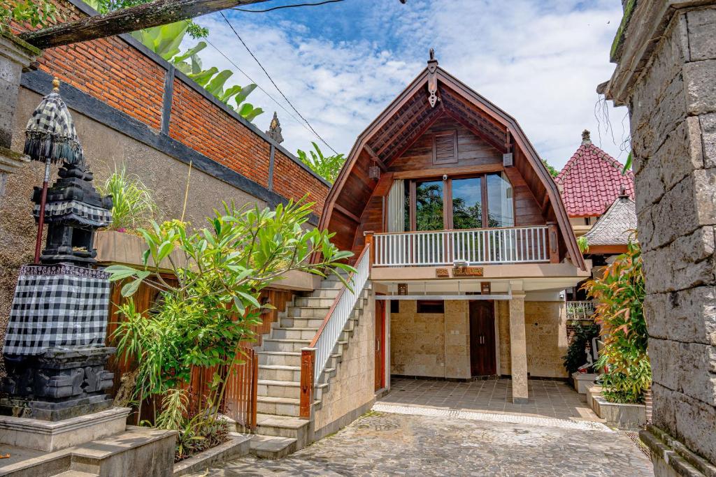 a house with a gambrel roof with a balcony at Villa AMPO unique Gazebo Flat in Munggu