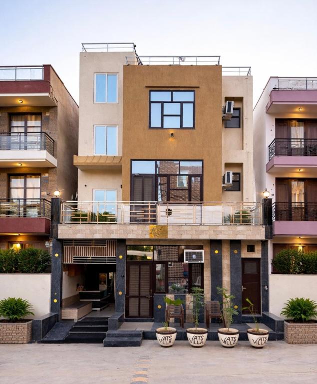 an apartment building with balconies and plants at VATS VILLA "Feels like Home & Facilitates like Hotel" in Vrindāvan