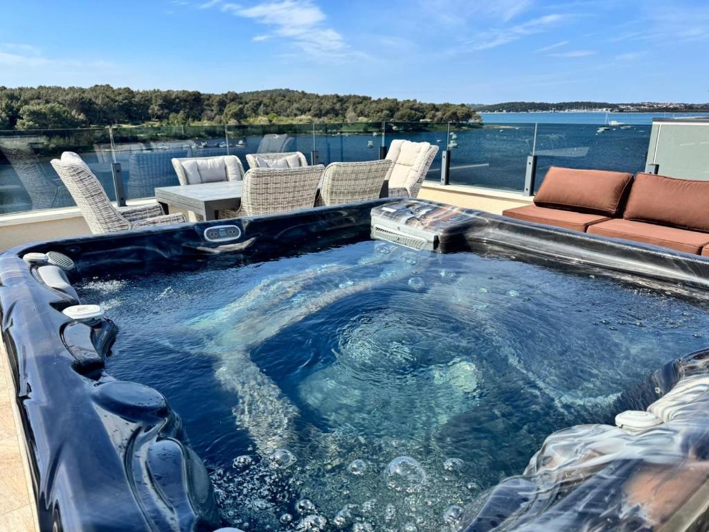 a jacuzzi tub with a view of the water at Apartman Moonlight Medulin in Medulin