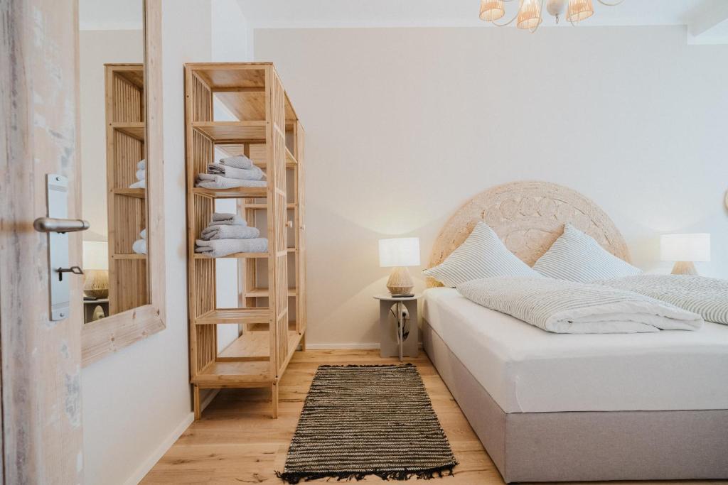 a bedroom with a bed and a book shelf at Boho - Suites I BRIGHT-Collection in Koblenz