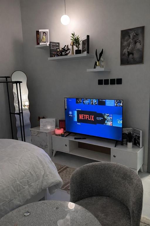 a living room with a flat screen tv on a stand at استديو بتصميم سينمائي in Buraydah