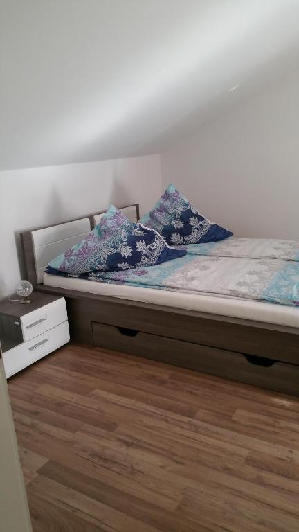 ein Bett mit zwei Kissen darauf in einem Schlafzimmer in der Unterkunft Ferienwohnung Blick auf die Berge in Pidingerau