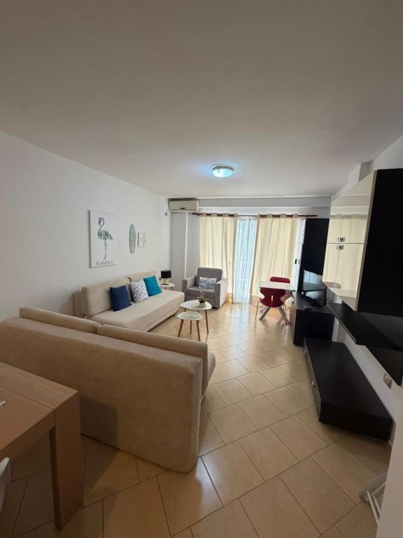 a living room with a couch and a table at Aldi APARTMENTS in Lezhë