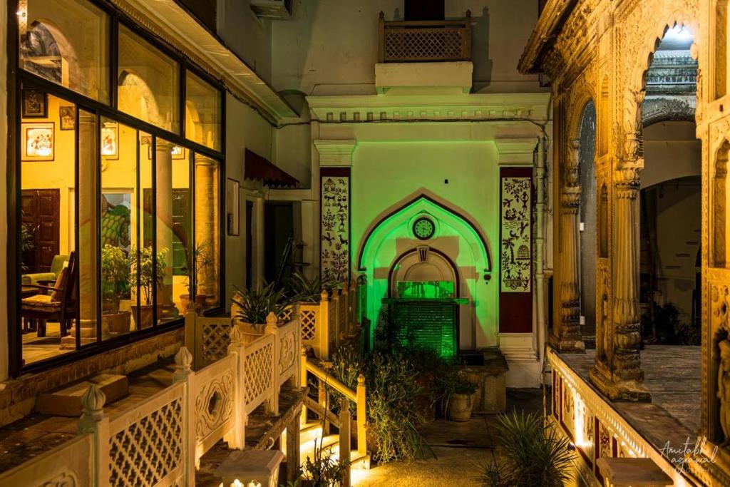 a building with a green door in a courtyard at Rudreshwar Mahadeo Kothi in Varanasi
