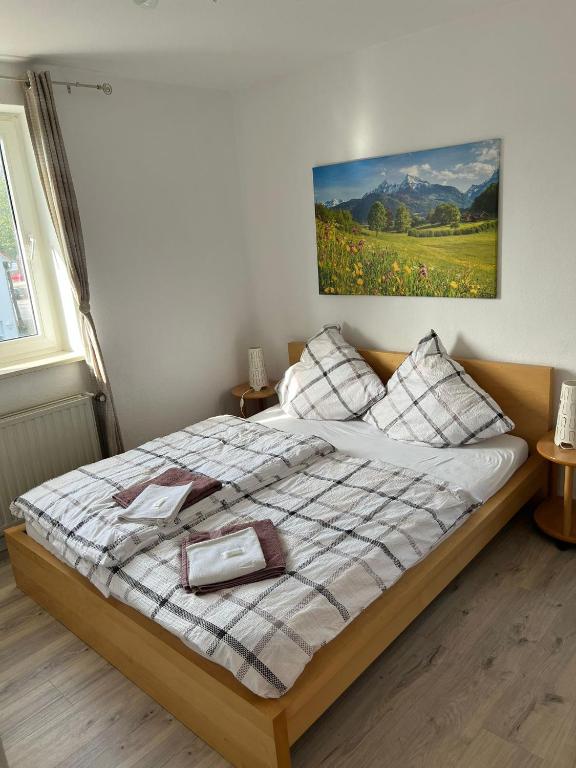 a bedroom with a bed with a picture on the wall at Caldener Hof in Calden