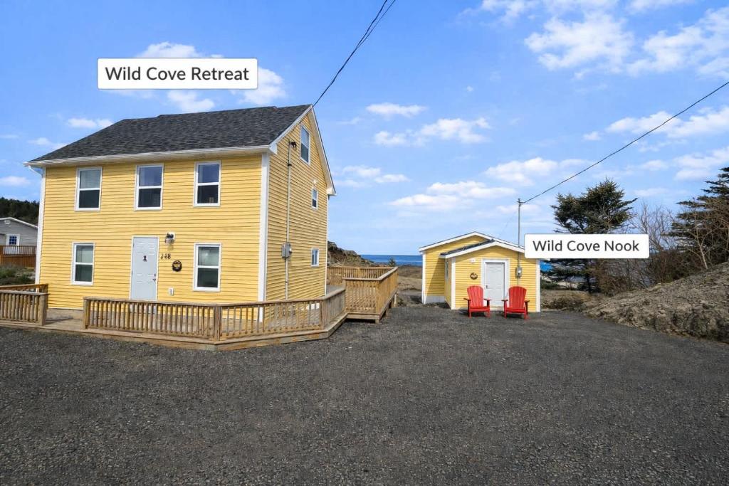 a small yellow house with a walk over roof at Wild Cove Retreat & Nook in Twillingate