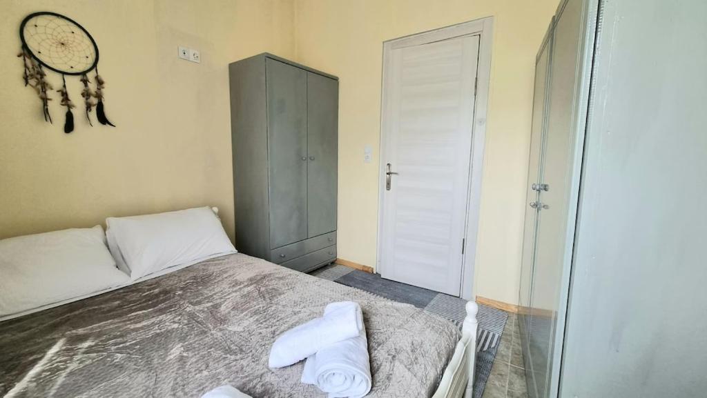 a bedroom with a bed with a clock on the wall at Julieta's house in Chios