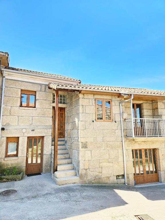 a stone house with a staircase in front of it at Casa García in Allariz