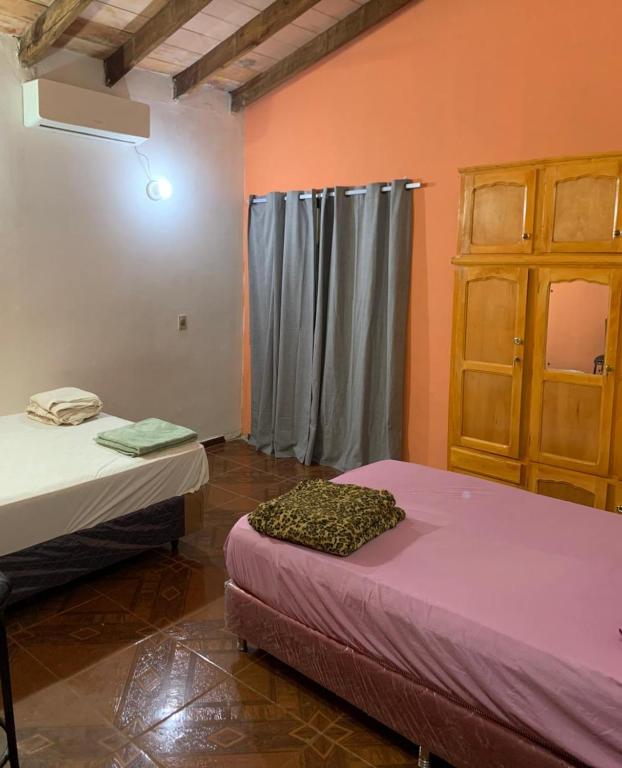 a room with two beds and a window in it at Habitación 4 in Asunción