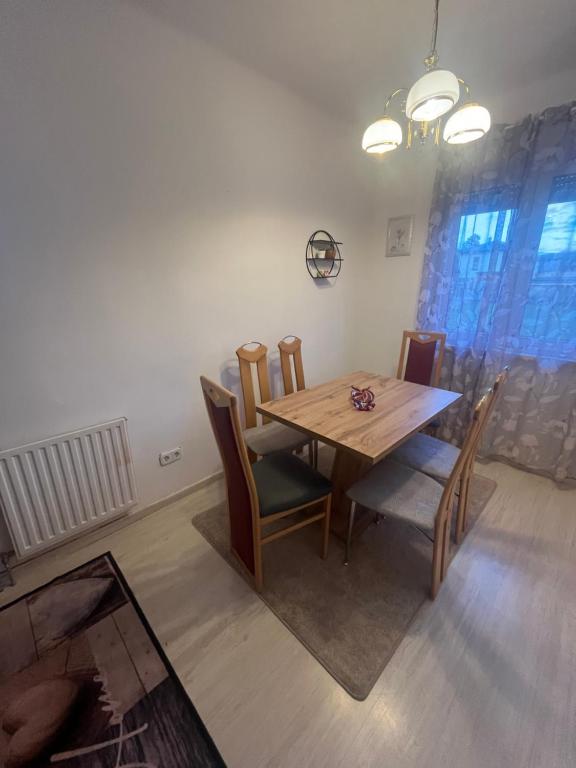 a dining room with a wooden table and chairs at Wohnung Sonja in Villach