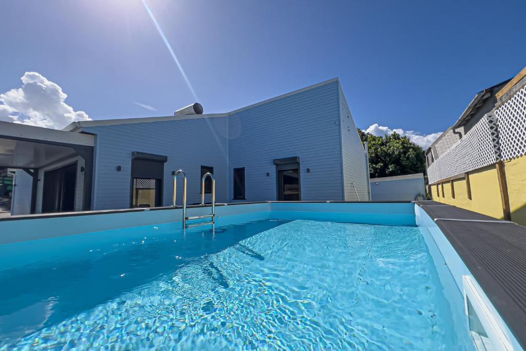 a large swimming pool in front of a building at Villa Coeur Bleu in Petit-Bourg