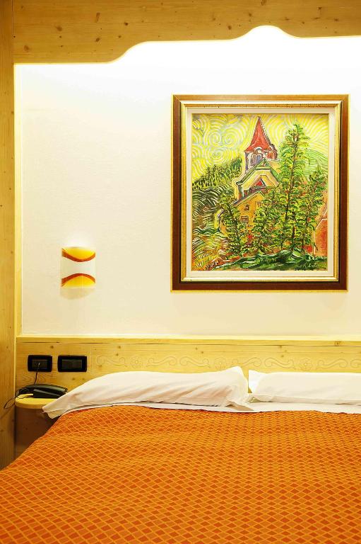 Postel nebo postele na pokoji v ubytování Hotel Raibl e Appartamenti