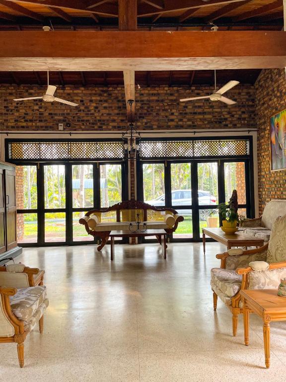 a large living room with a table and chairs at Airport Coconut Villas Free Oneway Airport Pick Drop in Henpitagedara