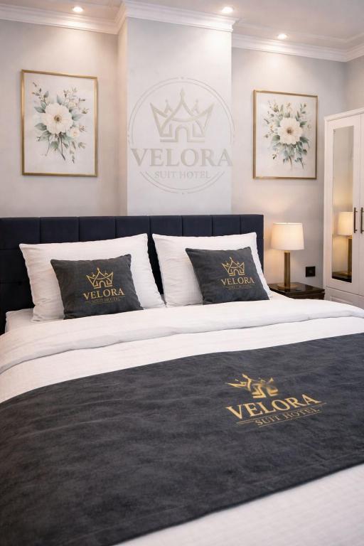 a bedroom with a bed with a black and white comforter at Velora Suit Hotel in Nevşehir