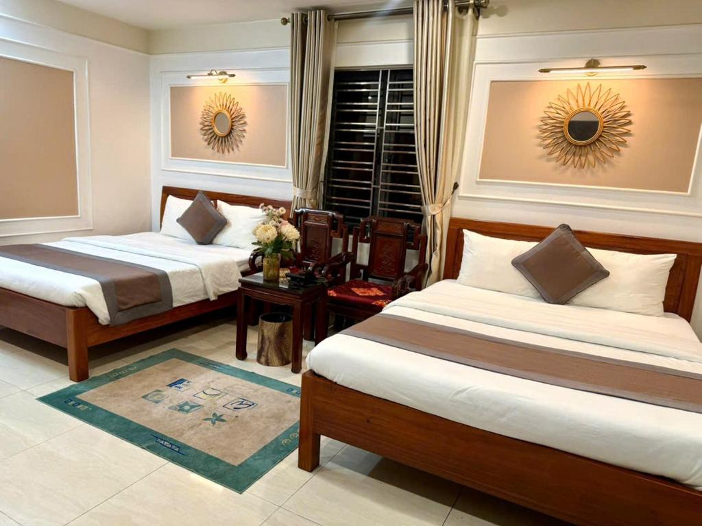 a hotel room with two beds and a window at hotel phúc khánh in An Dương