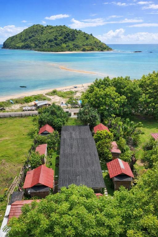 an aerial view of a resort with trees and the ocean at Ocean Fresh Surfhouse in Pulau Sarang
