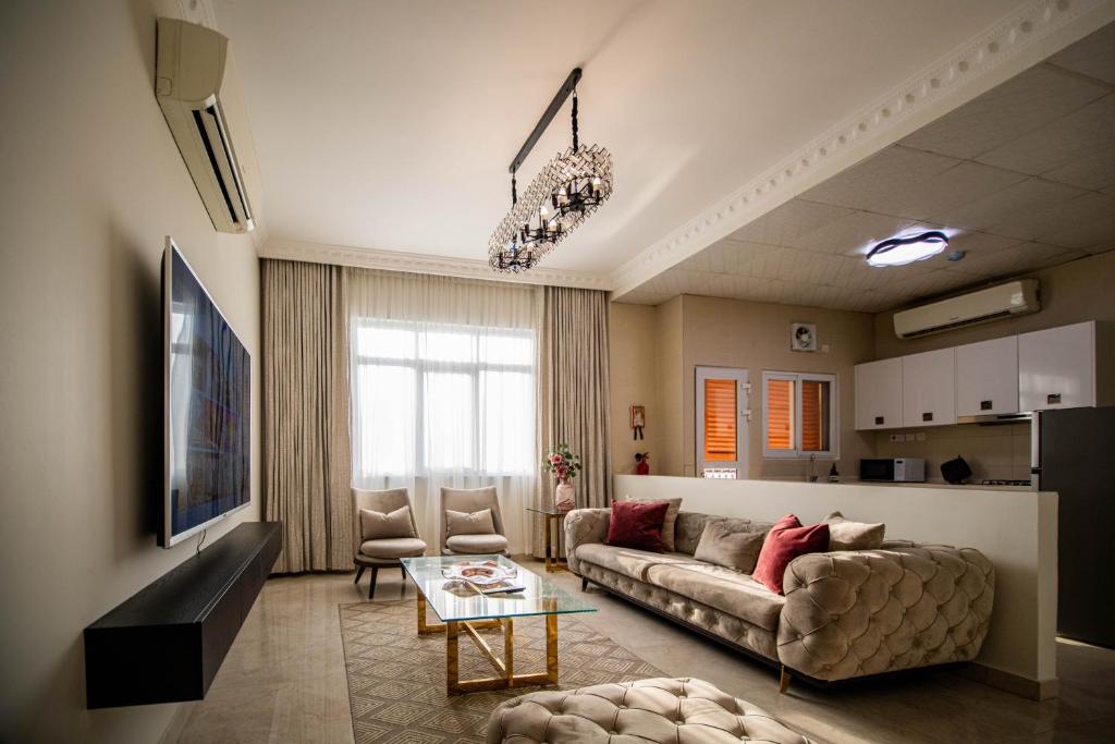 a living room with a couch and a table at Muscat Stays in Muscat