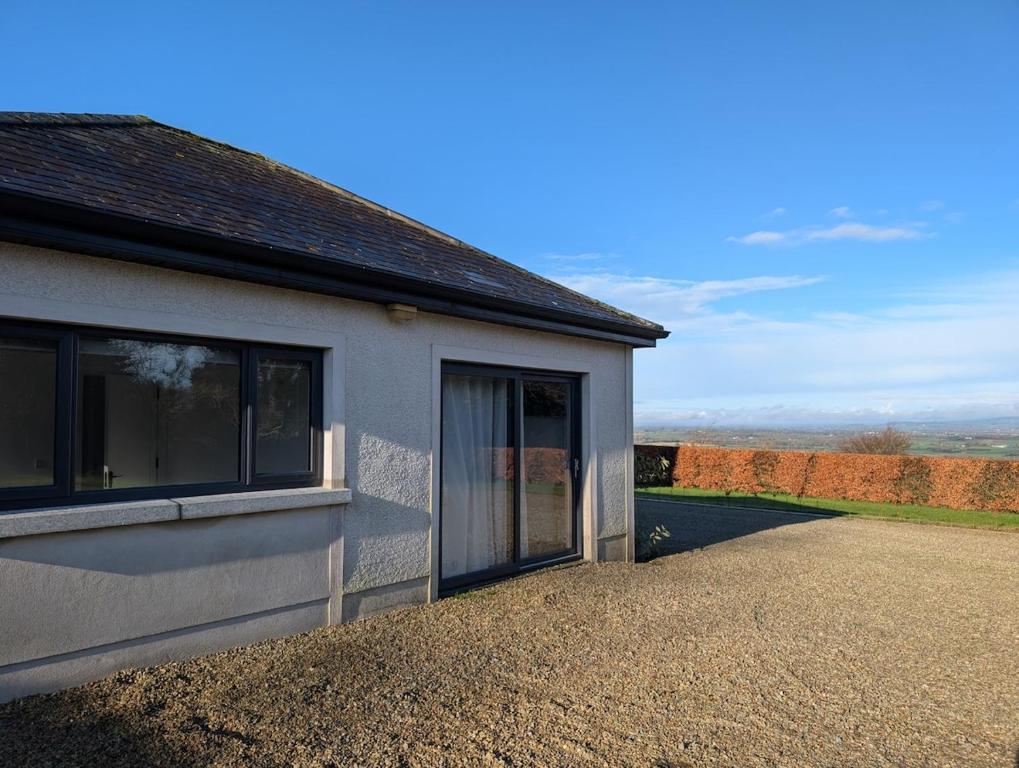 a house with a large window and a driveway at The Unplugged Snug in Kilkenny