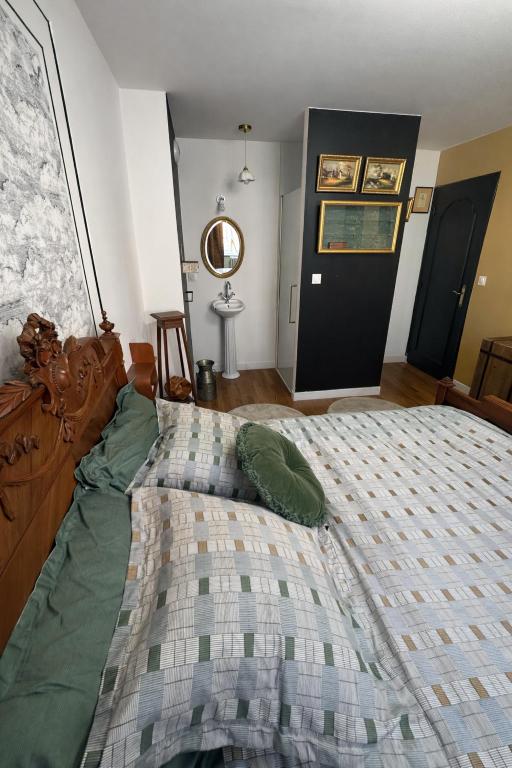 a bedroom with a large bed with pillows on it at B&B Villa Marie-Lou in Le Portel