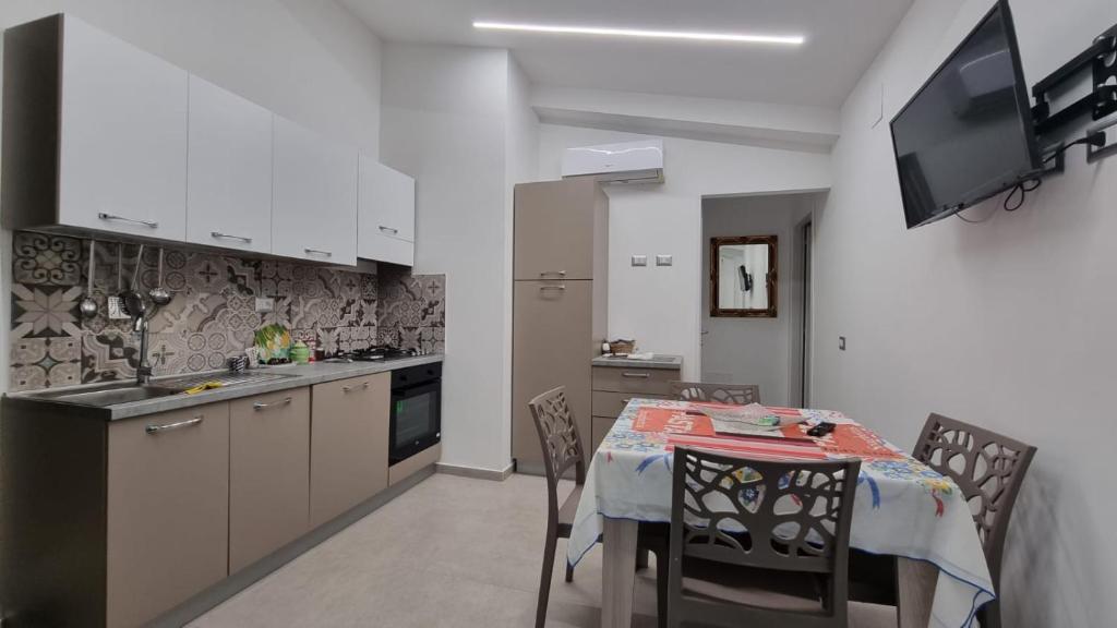 a kitchen and dining room with a table and chairs at Cilento My Home in Albanella