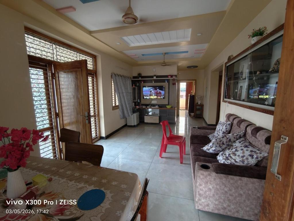 a living room with a couch and a table at Dev Homestay kakinada in Kākināda