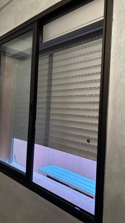 a window with a blind in a room at Andalous in Aït Ali