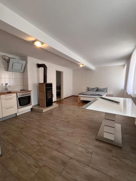 a large kitchen with a stove and a table at Main Tauber Appartment in Lauda-Königshofen