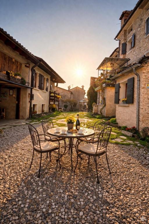 a table and chairs with a bottle of wine on it at Casa Angela-STAYERAT in Sequsino
