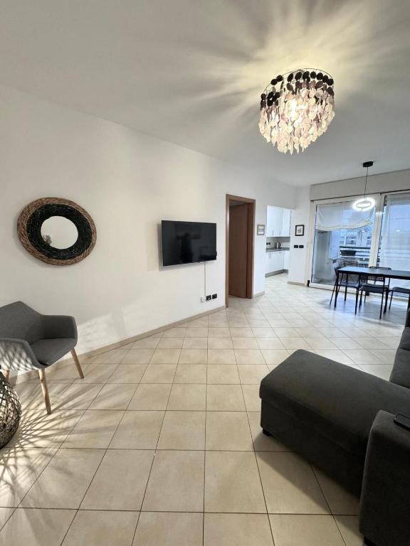 a living room with a couch and a tv at Torre Sole Fiumara in Genoa