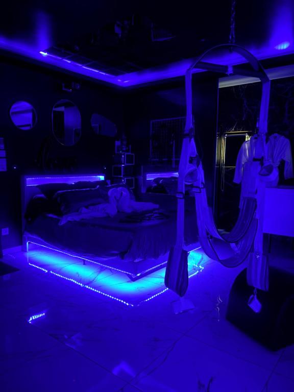 a dark room with two beds and blue lights at Hot Room Sainte Victoire in Trets