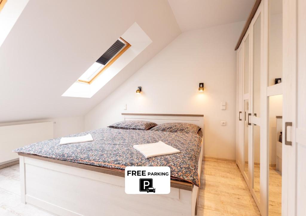 a bedroom with a bed with a free parking sign on it at Apartmány Holiday in Ostrava
