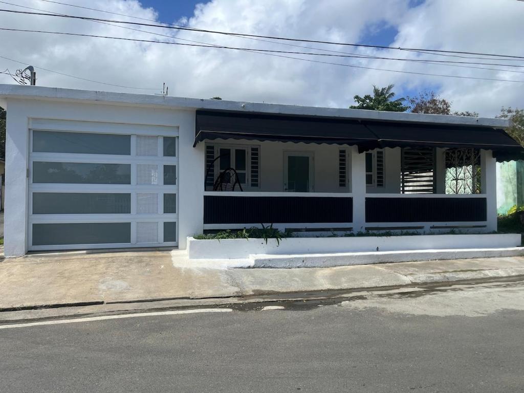 a white garage with a horse in the window at serenity in Fajardo