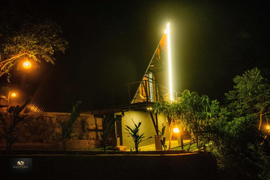 a church with a lit up steeple at night at HAVENRO Weligama in Weligama