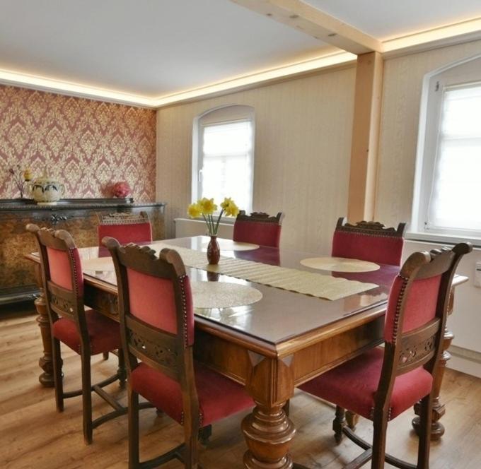a dining room with a table and chairs at Ferienwohnung Harmony "Residenz" in Leisnig