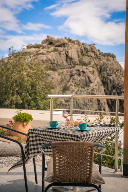 a table with two blue bowls on top at Vrachos Nature Lodges DAPHNE 2, Private pool in Agia Galini