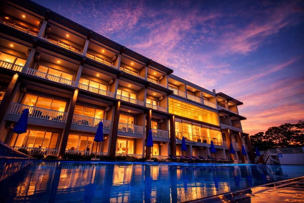 a large building with a pool in front of it at TBRS By Platinum Hotels in Trincomalee