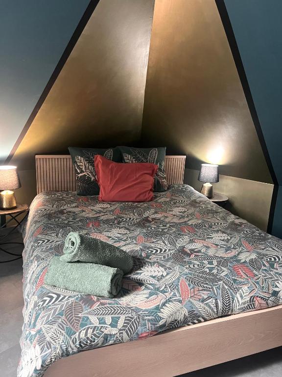 a bedroom with a large bed with a large bedspread at Suite l Instant suspendu maison 25m2 avec coin salon Wifi Netflix Maison Like and Love Duclair in Duclair
