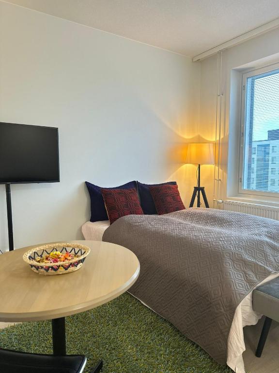a bedroom with a bed and a table and a couch at Appartment in Espoo in Helsinki