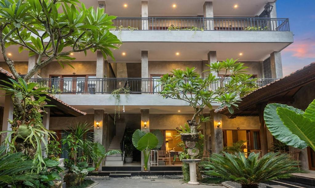 an exterior view of a building with trees and plants at Rumah Weda in Ubud