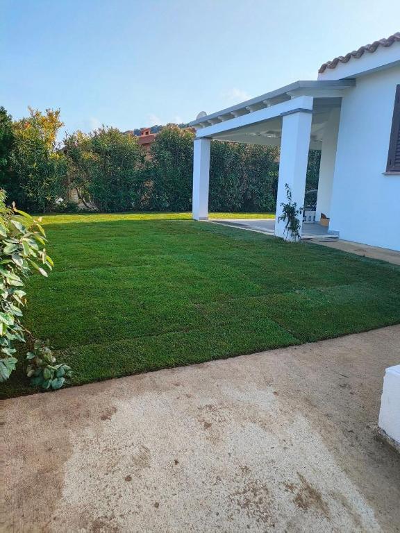 a large lawn in front of a house at Casa Cristina in Costa Rei