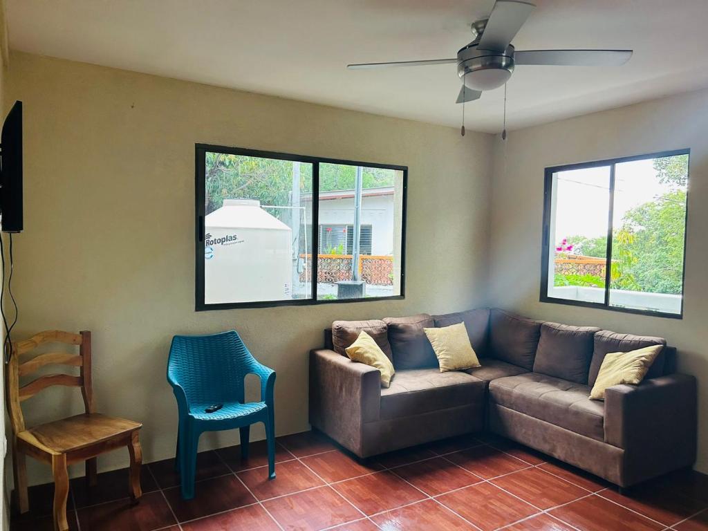 a living room with a couch and a chair at Apartamentos Isabela in Casares