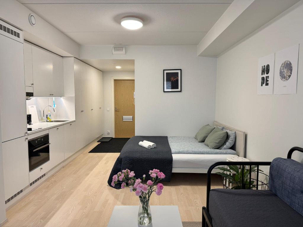 a small apartment with a bed and a kitchen at Easy Stay Rooms & Apartments near Airport in Vantaa