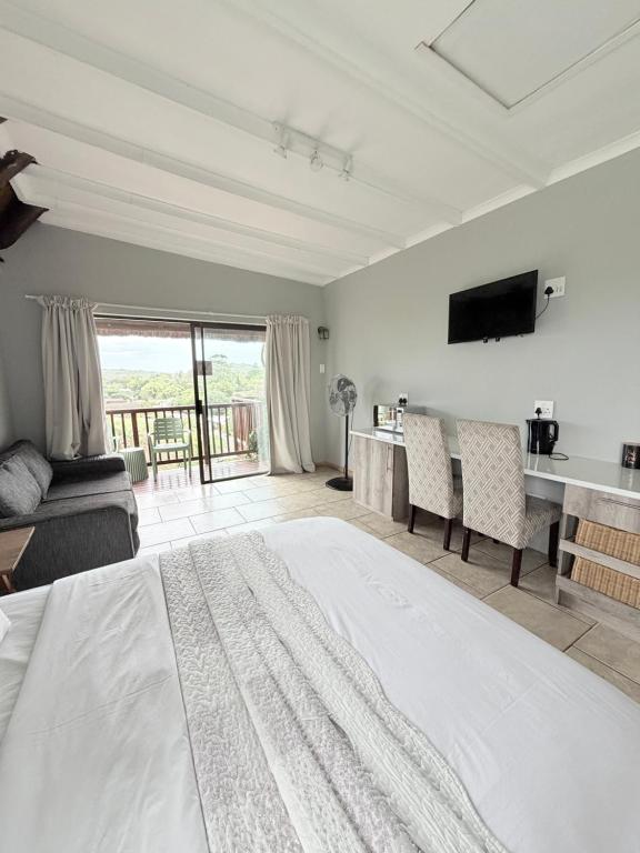 a large bedroom with a large bed and a television at The Hide on 37 Flamingo in East London