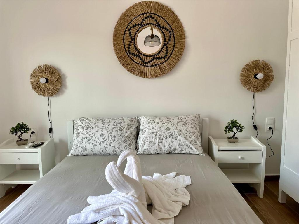 a bedroom with a bed with a mirror on the wall at Ekati in Xylokastro