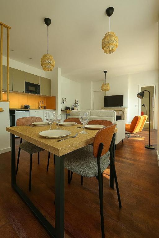 a dining table with wine glasses on it in a kitchen at La Tour d'Harfleur 1 in Caudebec-en-Caux