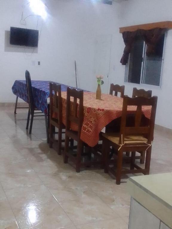 a dining room with a table and some chairs and a table and chairsktop at Hospedaje Ayla in Tinogasta