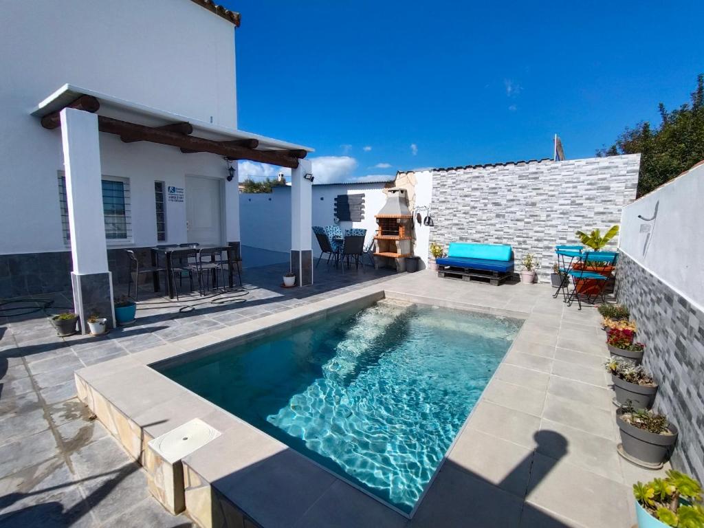 a swimming pool on a patio with a house at La magia del sur 2 in Cádiz