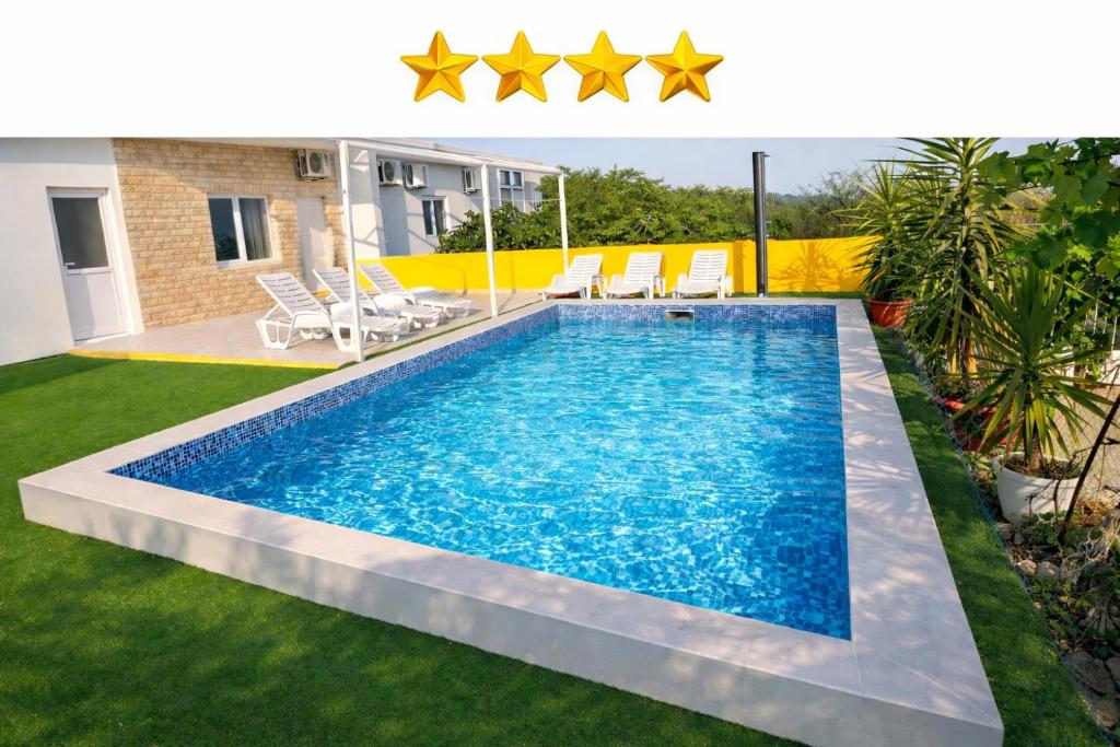 a swimming pool in a yard with stars above it at Villa Andy -private yard, swimming pool, panoramic view in Imotski