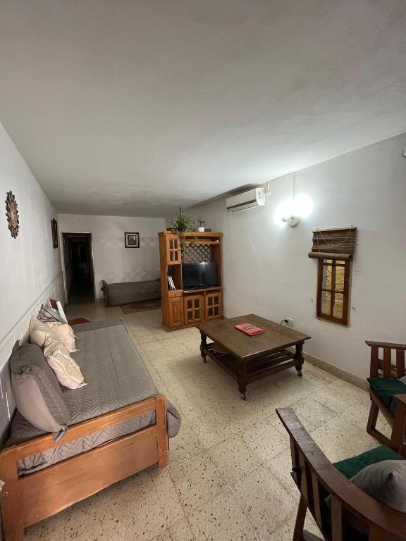 a living room with a couch and a table at Casa Mitre in Luján