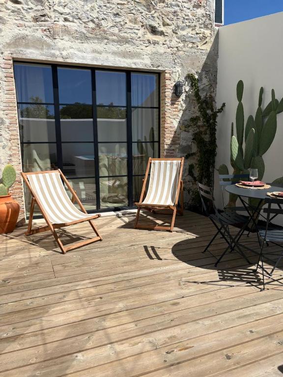 two chairs and a table on a patio at Casa Amanhada Apartamento Zero in Grândola